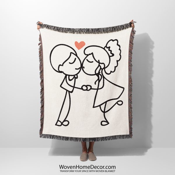 A Minimalist Love Sketch woven blanket, held up by an unseen person