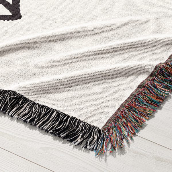 Close-up of the subtle, minimalist sketch design woven into the blanket