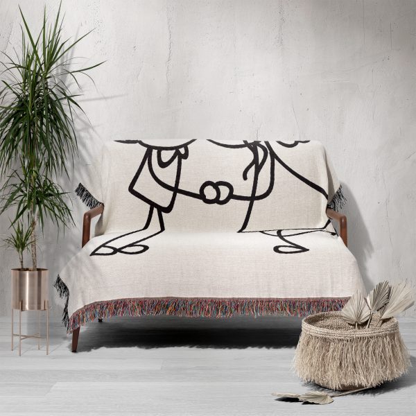 The Minimalist Love Sketch blanket draped over a sofa, giving a simple and chic look