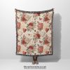 A Romantic Floral and Heart Motif woven blanket, held up by an unseen person