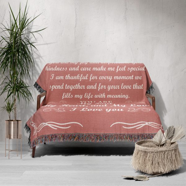 The Romantic Girlfriend Woven Blanket spread over a sofa, adding a romantic touch to the space.