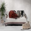 The Romantic Skeleton Couple blanket covering a sofa, creating a unique and romantic vibe