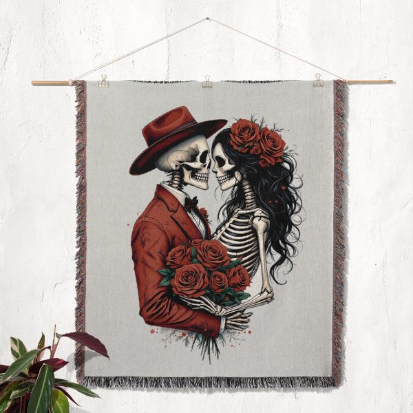 The Romantic Skeleton Couple blanket displayed on a wall as a tapestry