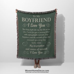 A woman holds the To My Boyfriend Woven Blanket, displaying its sleek design and meaningful message.