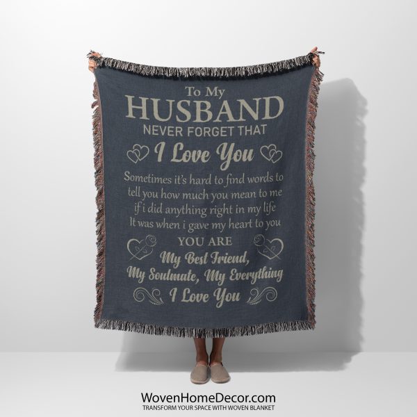 A woman holds the To My Husband Woven Blanket, highlighting the emotional message and sophisticated design.