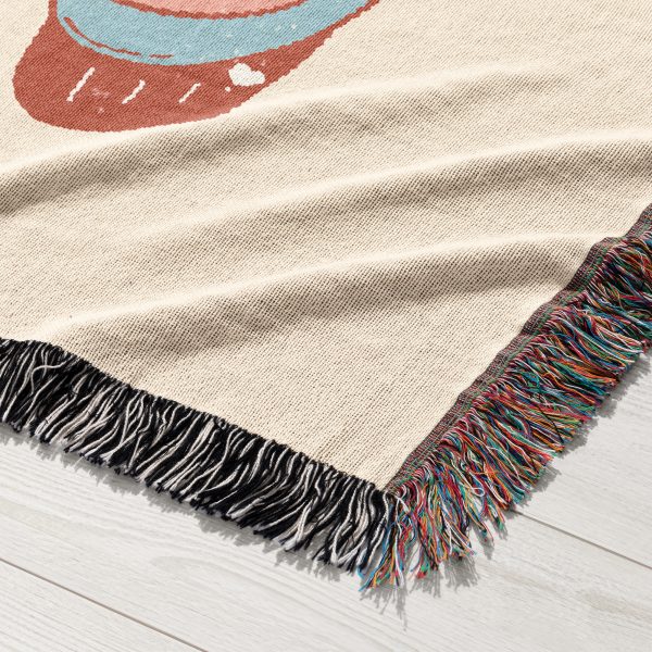 Close-up of the vintage car and bear design woven into the blanket