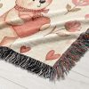 Close-up of the playful bear and balloon design on the woven blanket