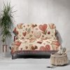 The Whimsical Bear and Balloon Love blanket draped over a sofa, adding charm to the room