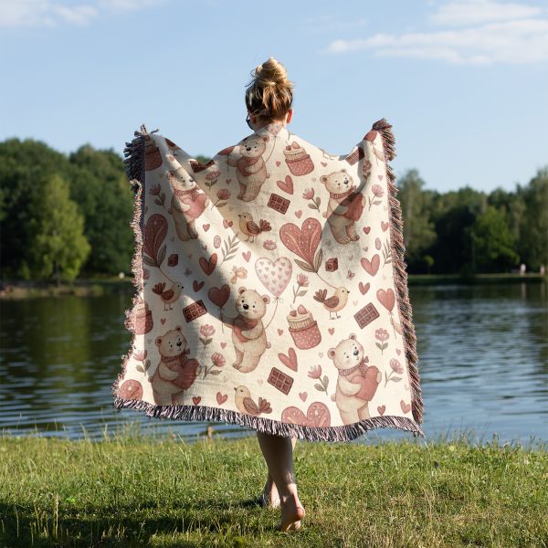 A person standing by a lake, wrapped in the Whimsical Bear and Balloon Love blanket, view from behind